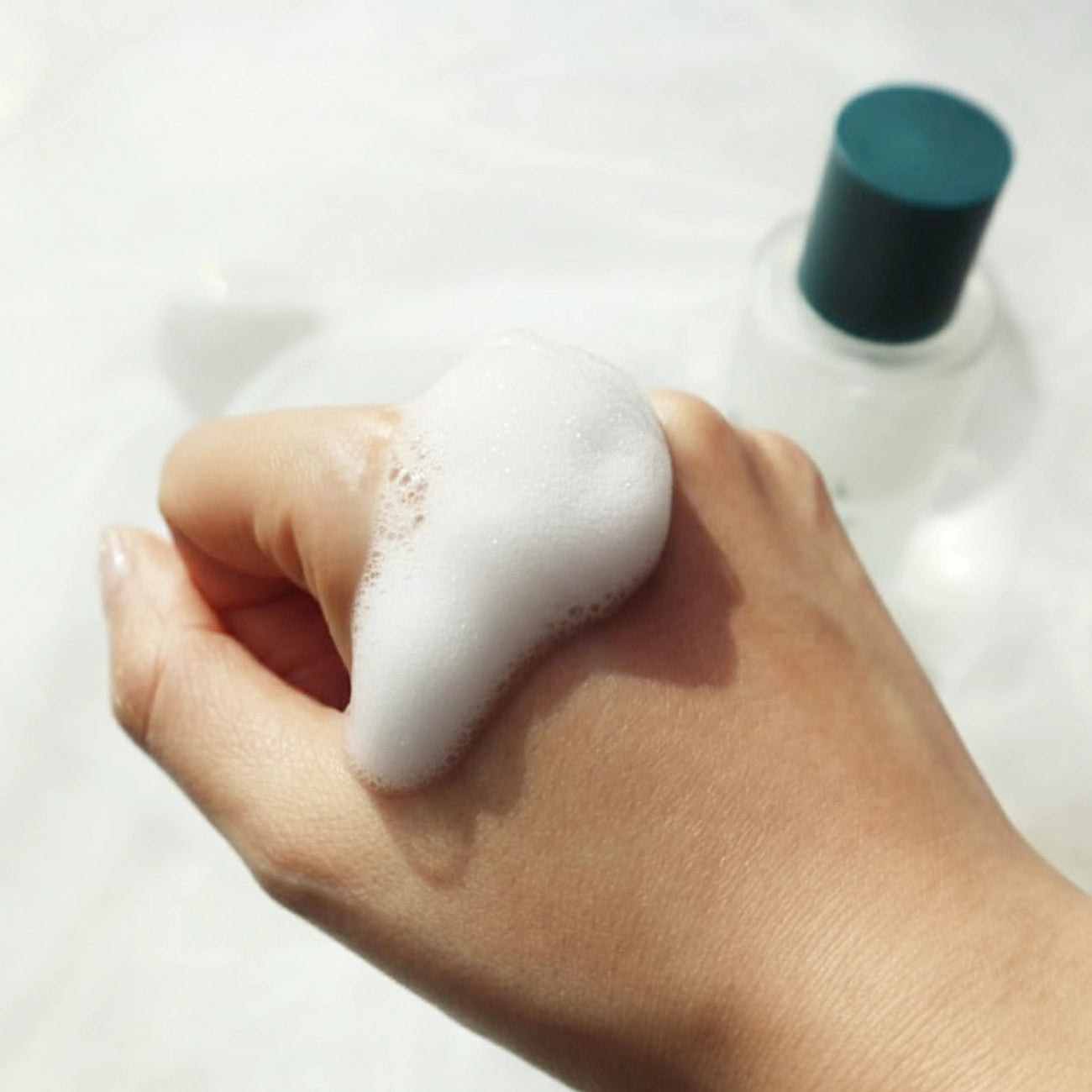 Foamy bubble texture created with BACIEL Bubble Maker showing rich and dense lather on hand